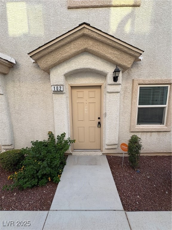View of exterior entry with stucco siding