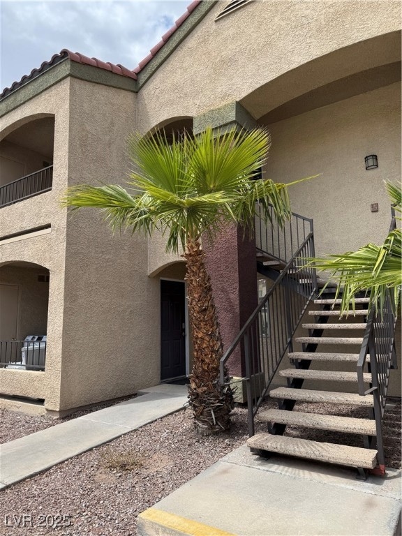 Doorway to property with stucco siding