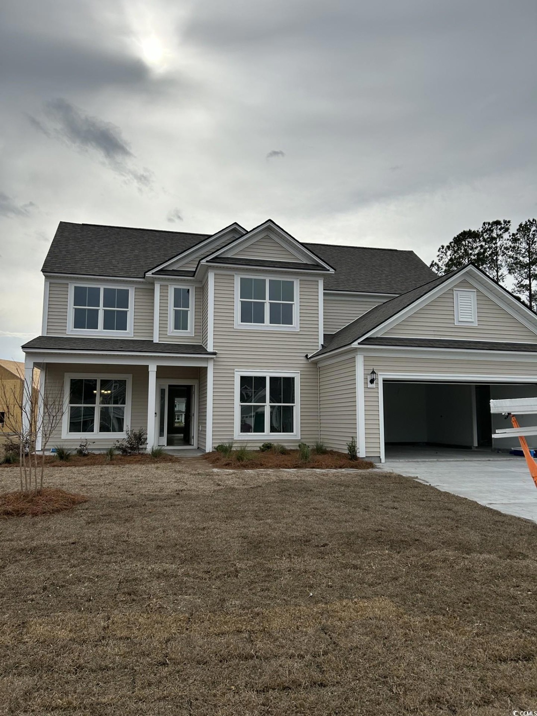 View of front facade featuring a garage, a carport