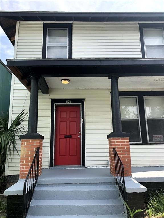 View of exterior entry with covered porch