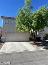 View of front of home with a garage and driveway