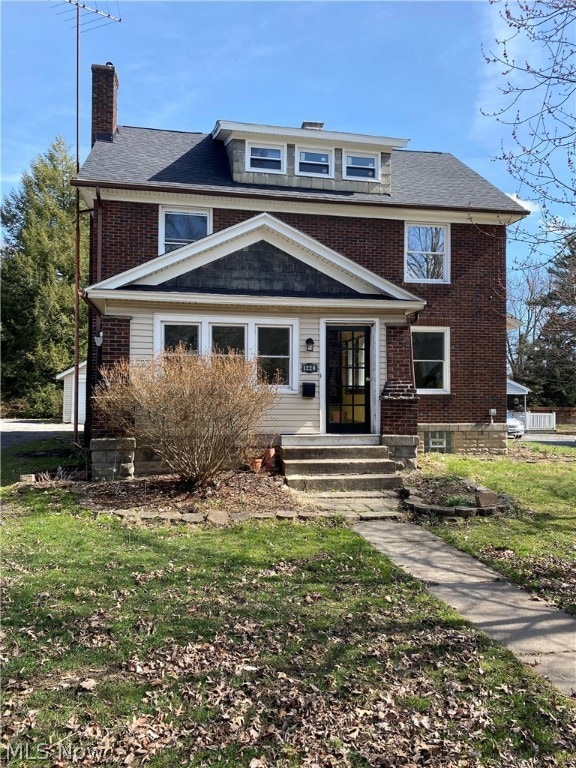 Front of the home with a front sidewalk and yard.