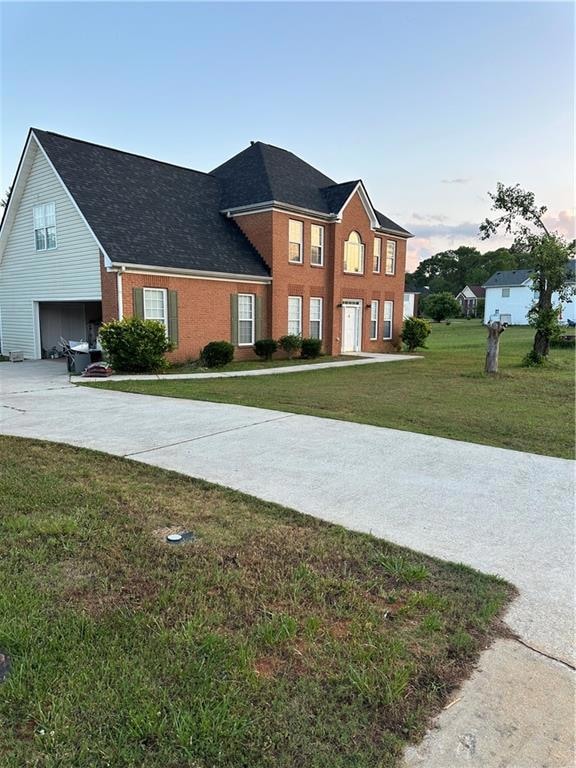 View of front of home featuring a garage and a law