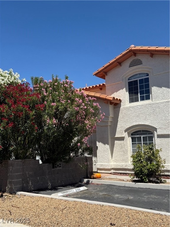 View of front of home featuring a tiled roof and s