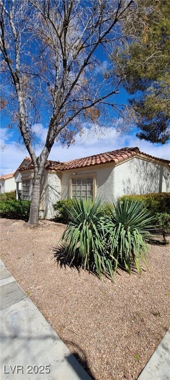 View of property exterior with stucco siding and a