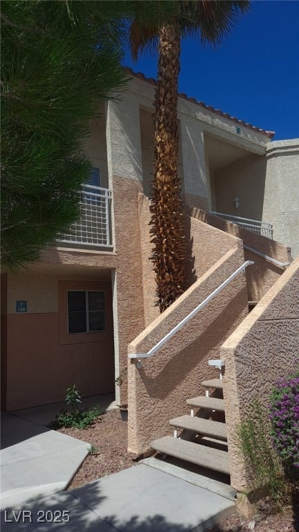 View of side of property featuring stucco siding