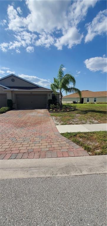 Single story home with decorative driveway and an 