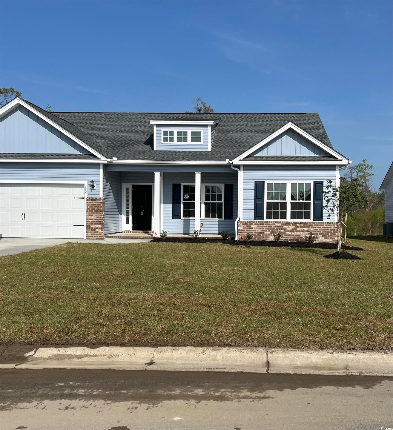 View of front of house with driveway, a front yard
