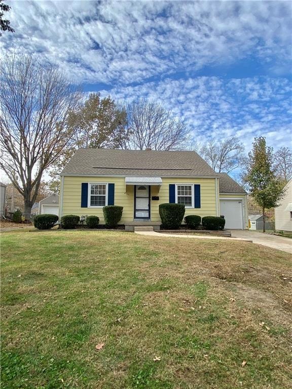 Ranch-style house featuring a front lawn, a garage, driveway, and roof with shingles