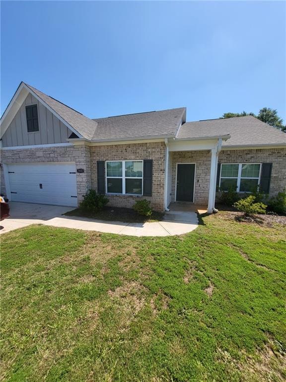 Single story home with a front yard, concrete driveway, a garage, and roof with shingles