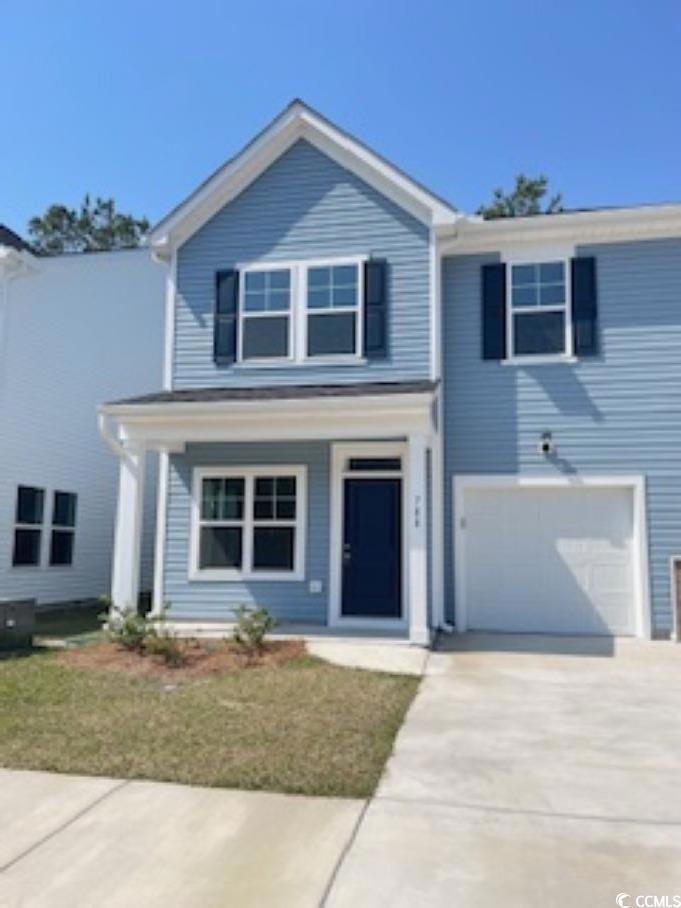 View of front of home featuring an attached garage, concrete driveway, covered porch, and a shingled roof