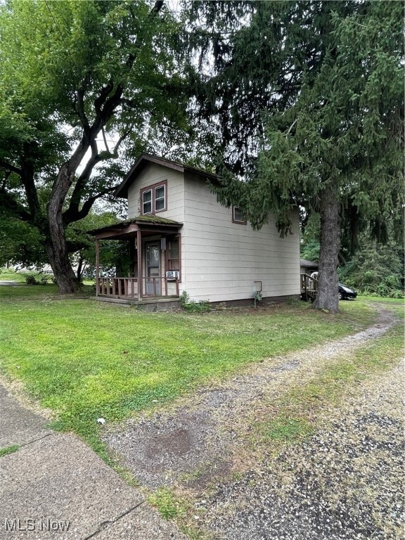 View of front of home featuring a front yard and covered porch