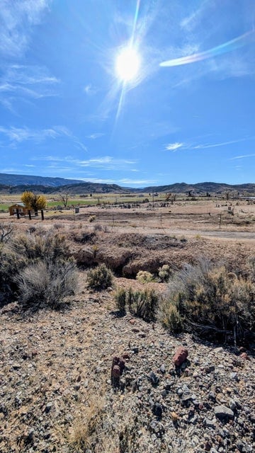 View of mountain backdrop with rural landscape