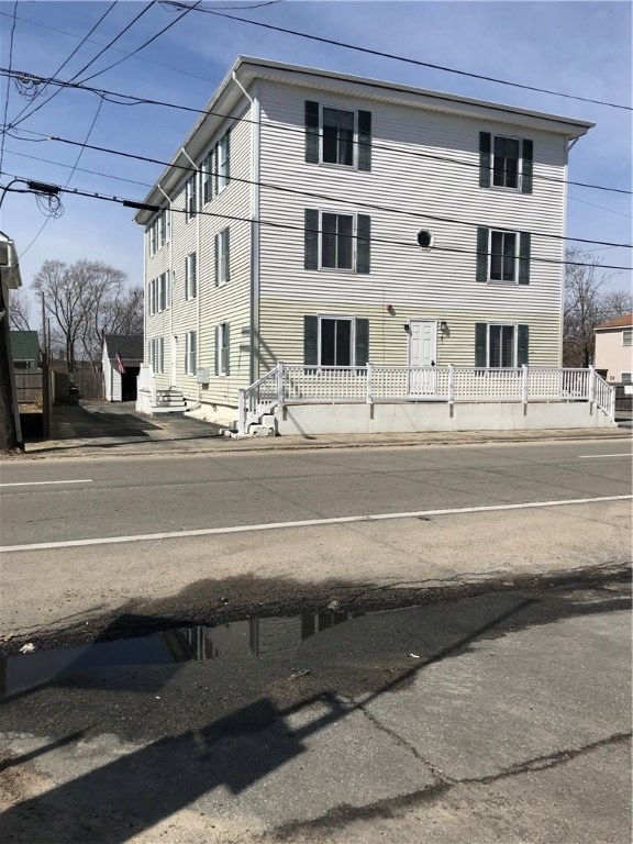 Front of building, south side driveway and garage