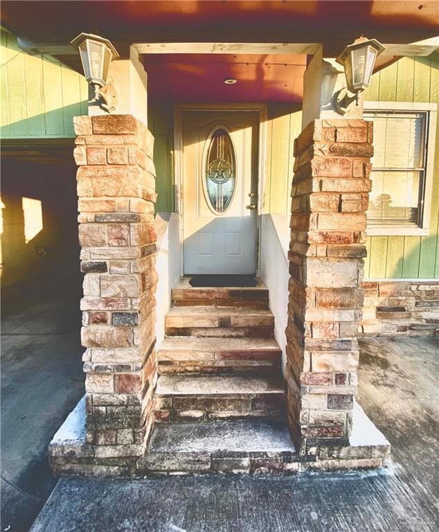 Doorway to property with stone siding