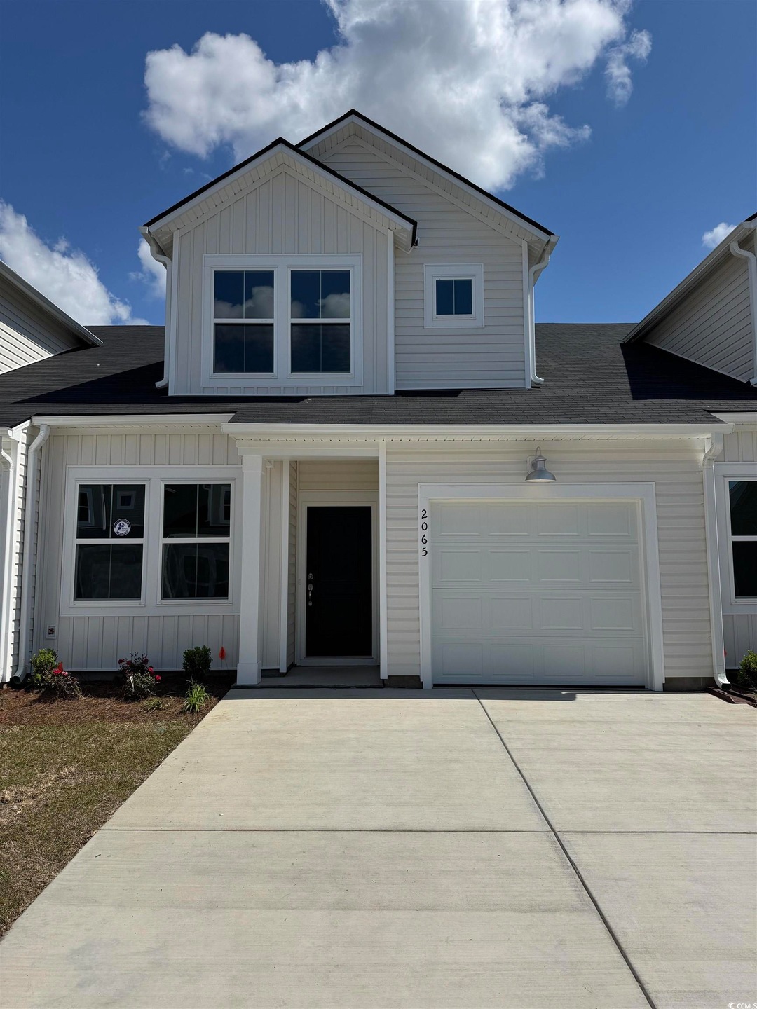 View of front of home with concrete driveway, an a