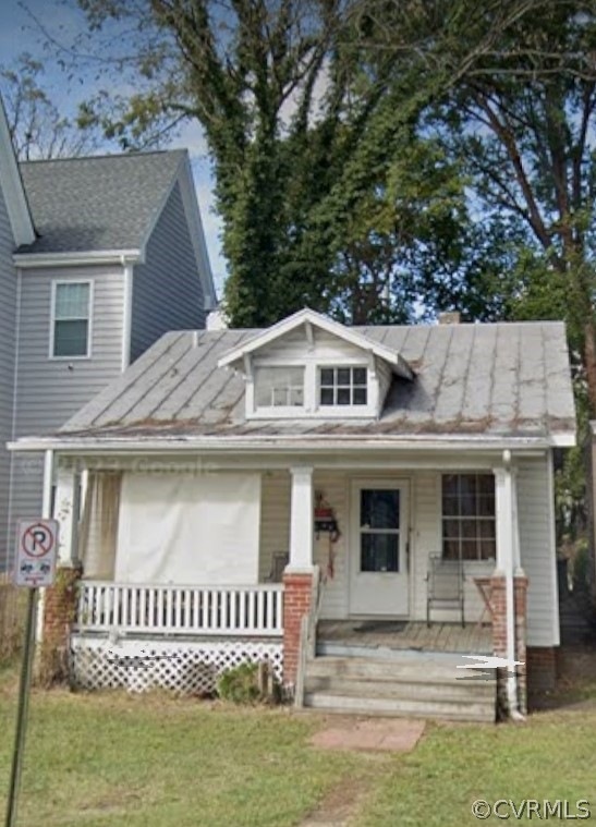 View of front of home featuring covered porch and