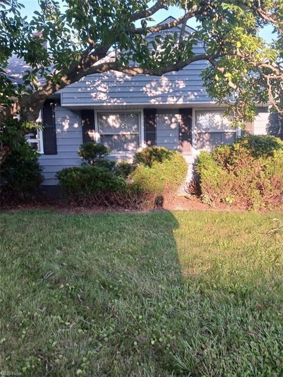 View of property exterior featuring a lawn