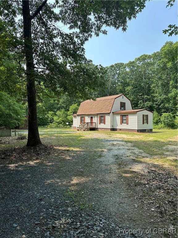 Dutch colonial with a gambrel roof and driveway