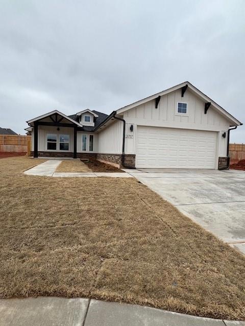 Single story home with a garage and a front yard