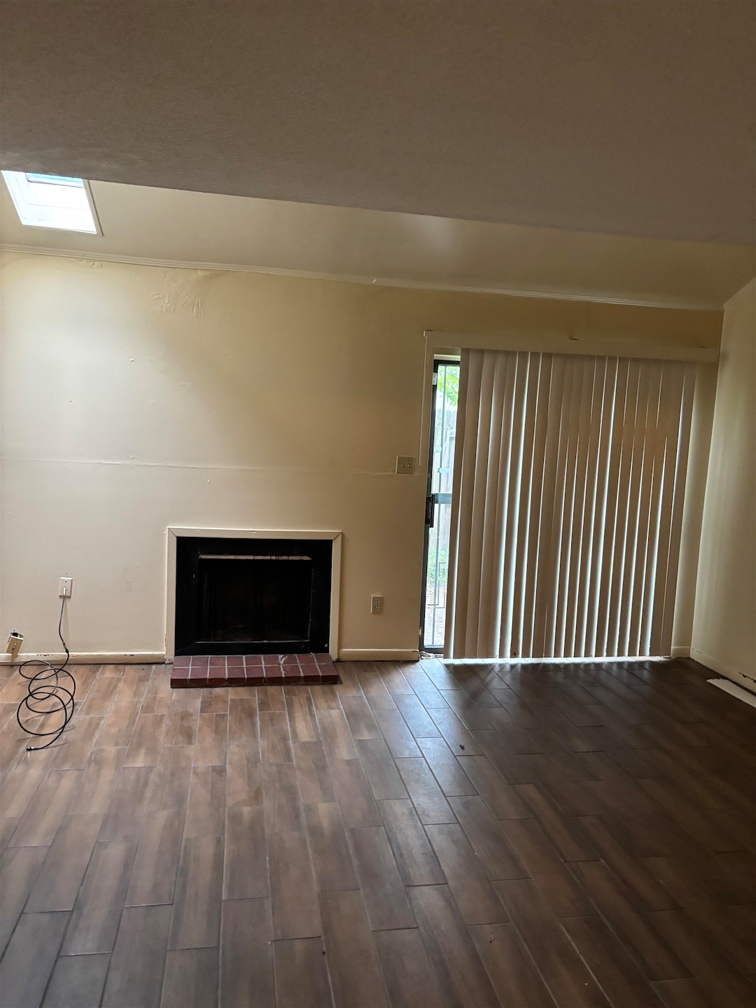 Unfurnished living room with baseboards, wood fini