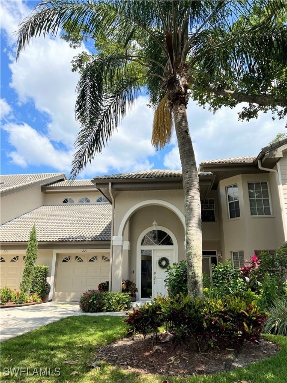 Mediterranean / spanish home with driveway, stucco