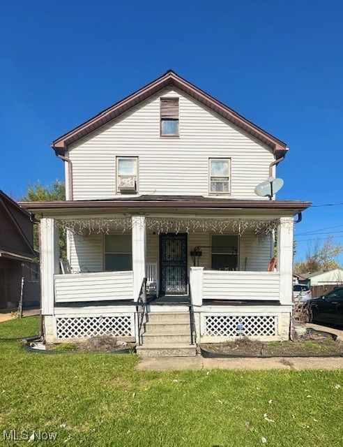 View of front facade with a porch and a front lawn