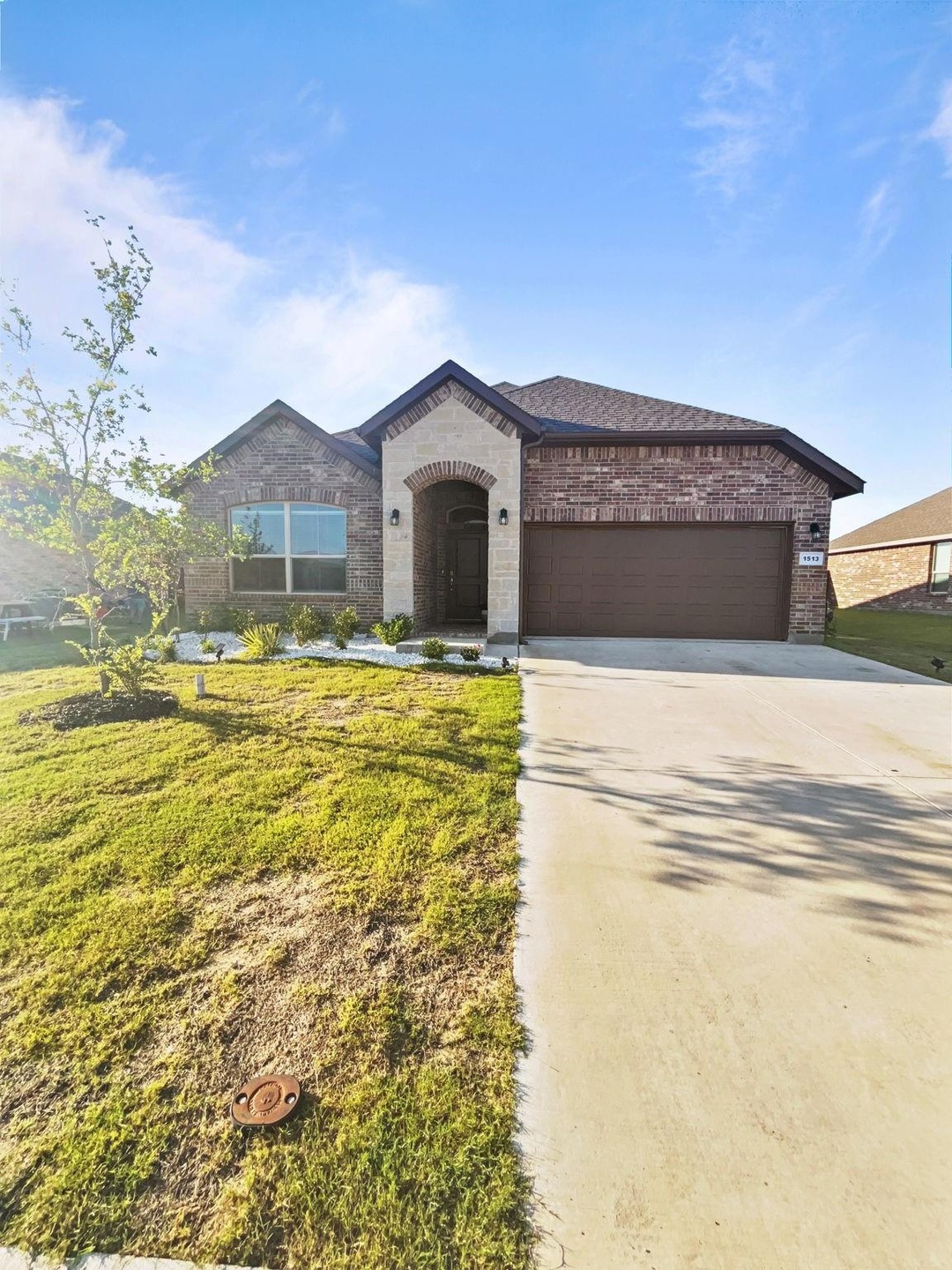 View of front of house featuring a garage and a front lawn