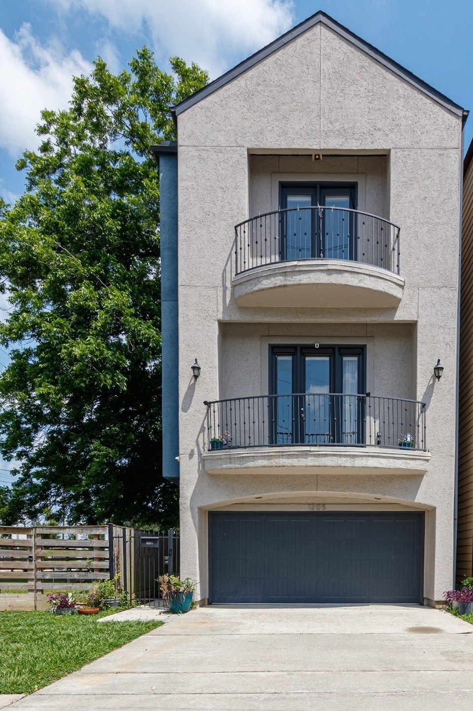 Modern three-story townhouse with a stucco facade