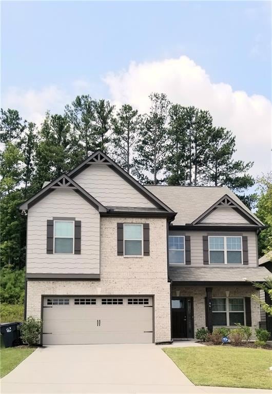 Craftsman-style house with a garage and a front la