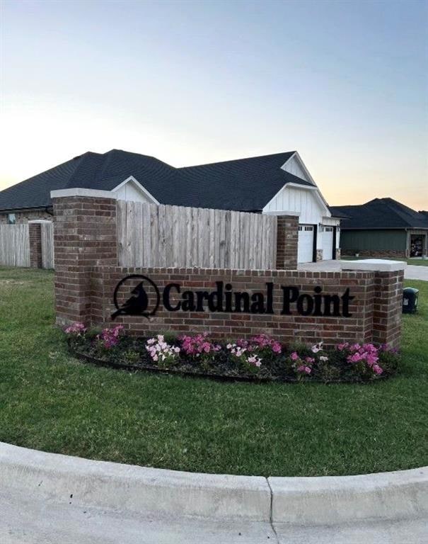 Community / neighborhood sign with a yard