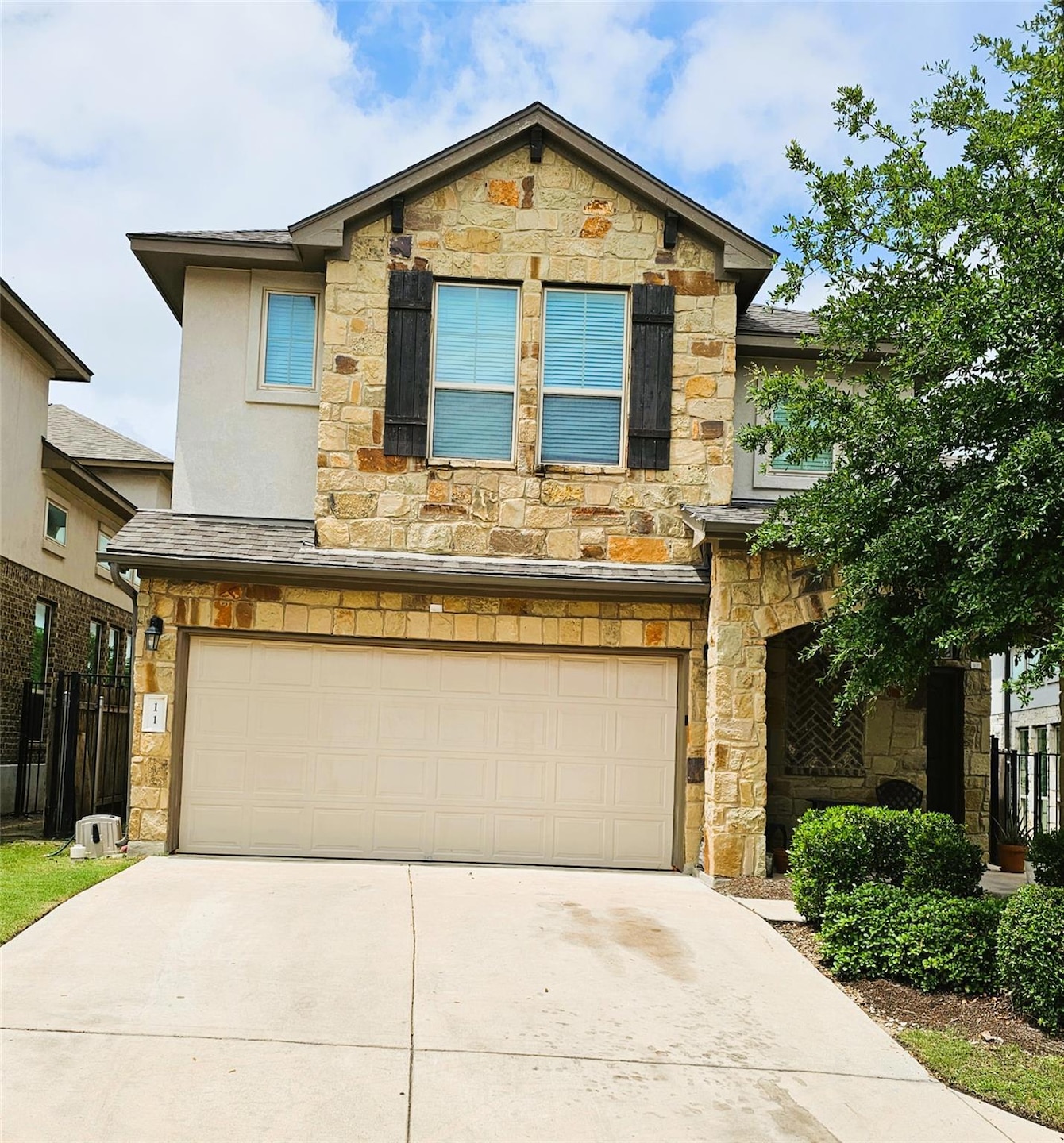 View of front of home featuring stone siding, an 