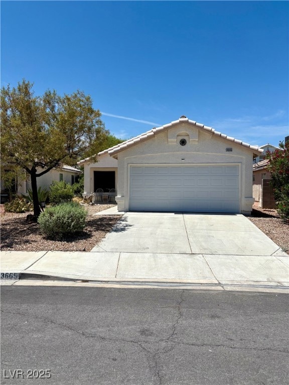 View of front facade with concrete driveway, stucc