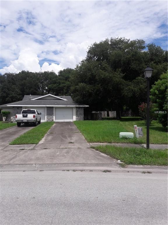 Welcome home! Long driveway, large yard with tree 