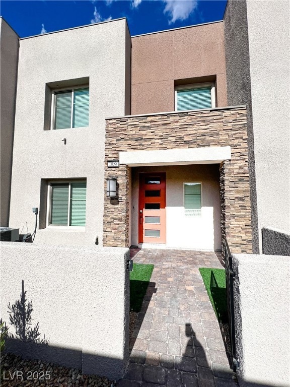 Contemporary home with stucco siding, stone siding