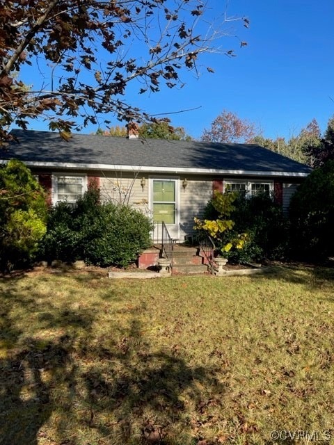Back of property with a yard