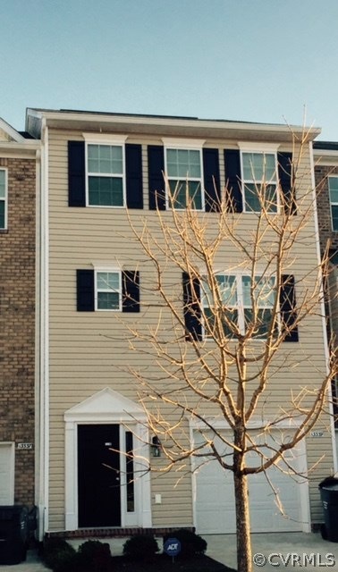 Front with attached garage and landscaping