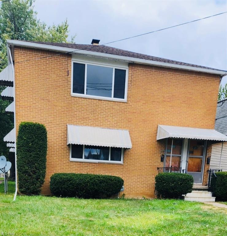 View of front of property with a front yard