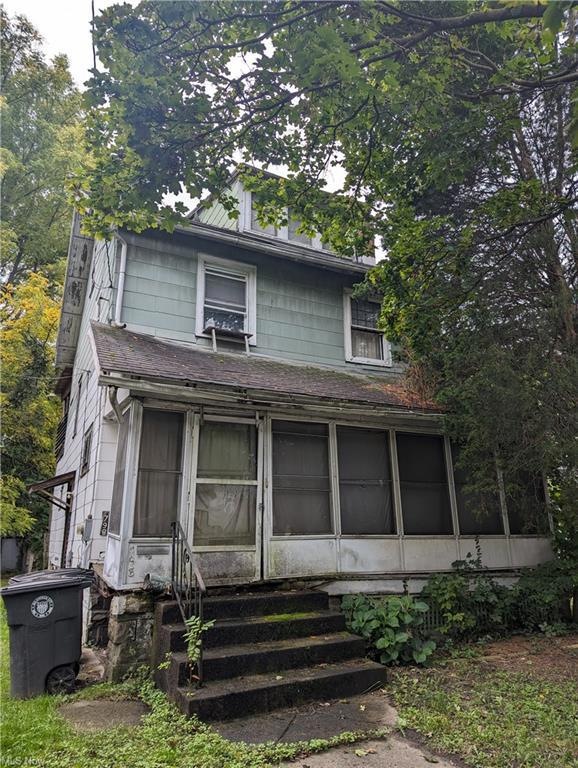 View of front of property with a sunroom