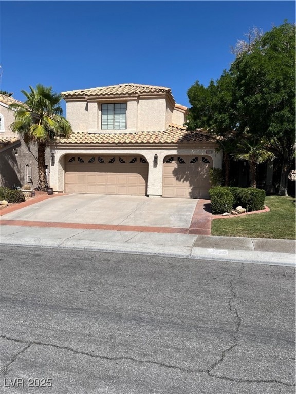 Mediterranean / spanish-style house with driveway,