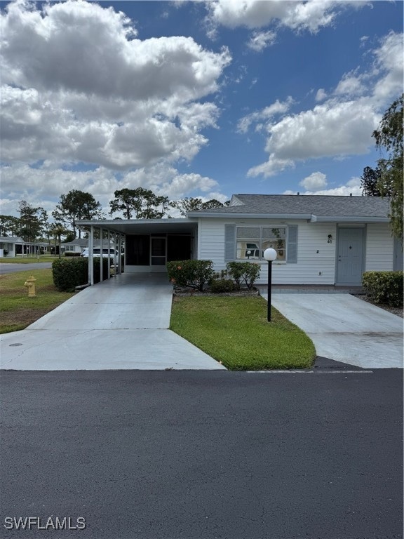 Ranch-style house featuring concrete driveway, a f