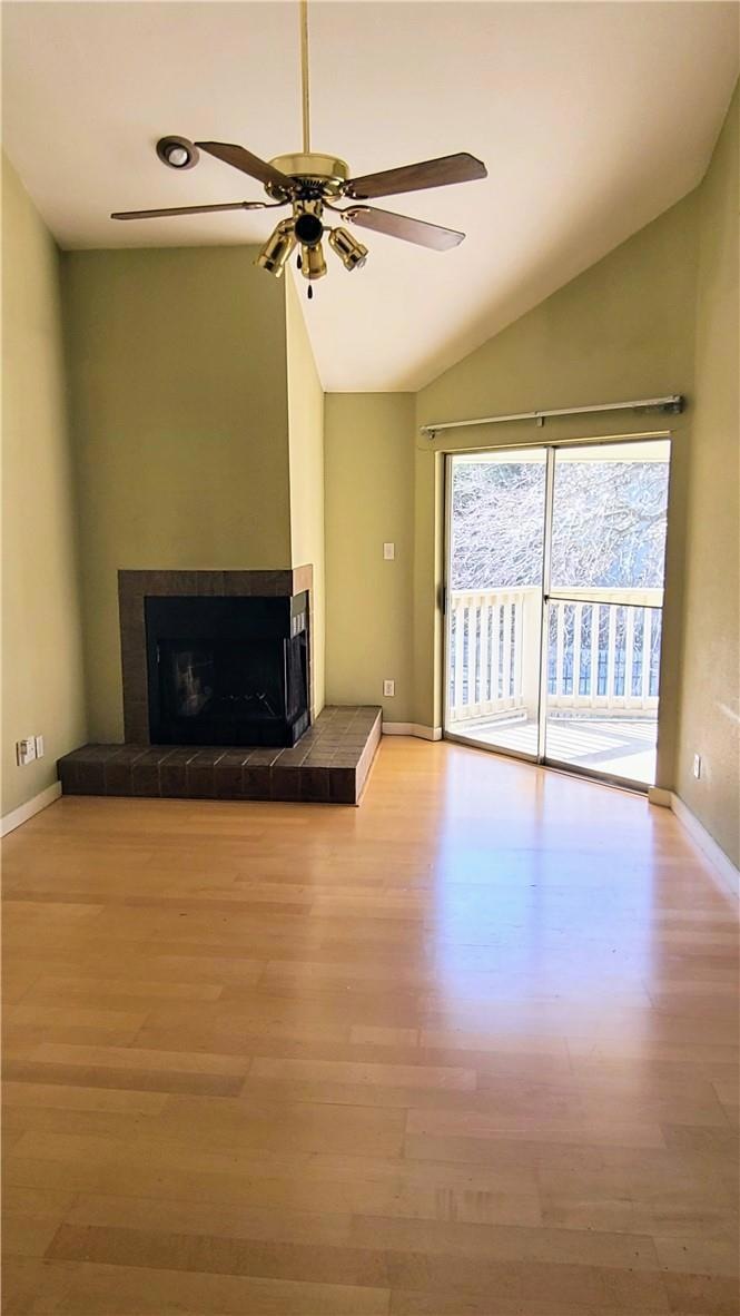 Unfurnished living room with a tiled fireplace, w