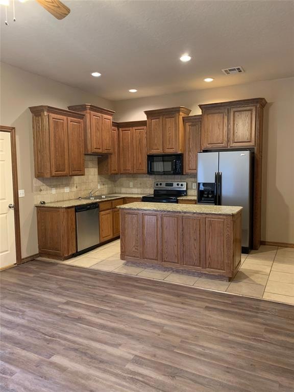 Kitchen with stainless steel appliances, ceiling f