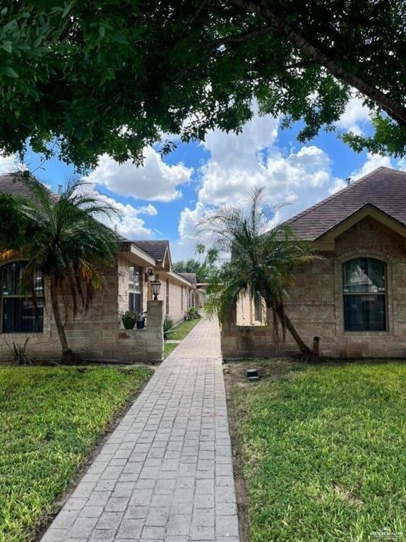 View of property's community featuring a yard