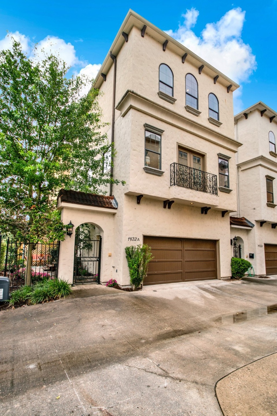 This elegant Tuscan-style three-story home offers