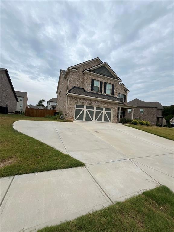 View of front of property with a garage and a fron
