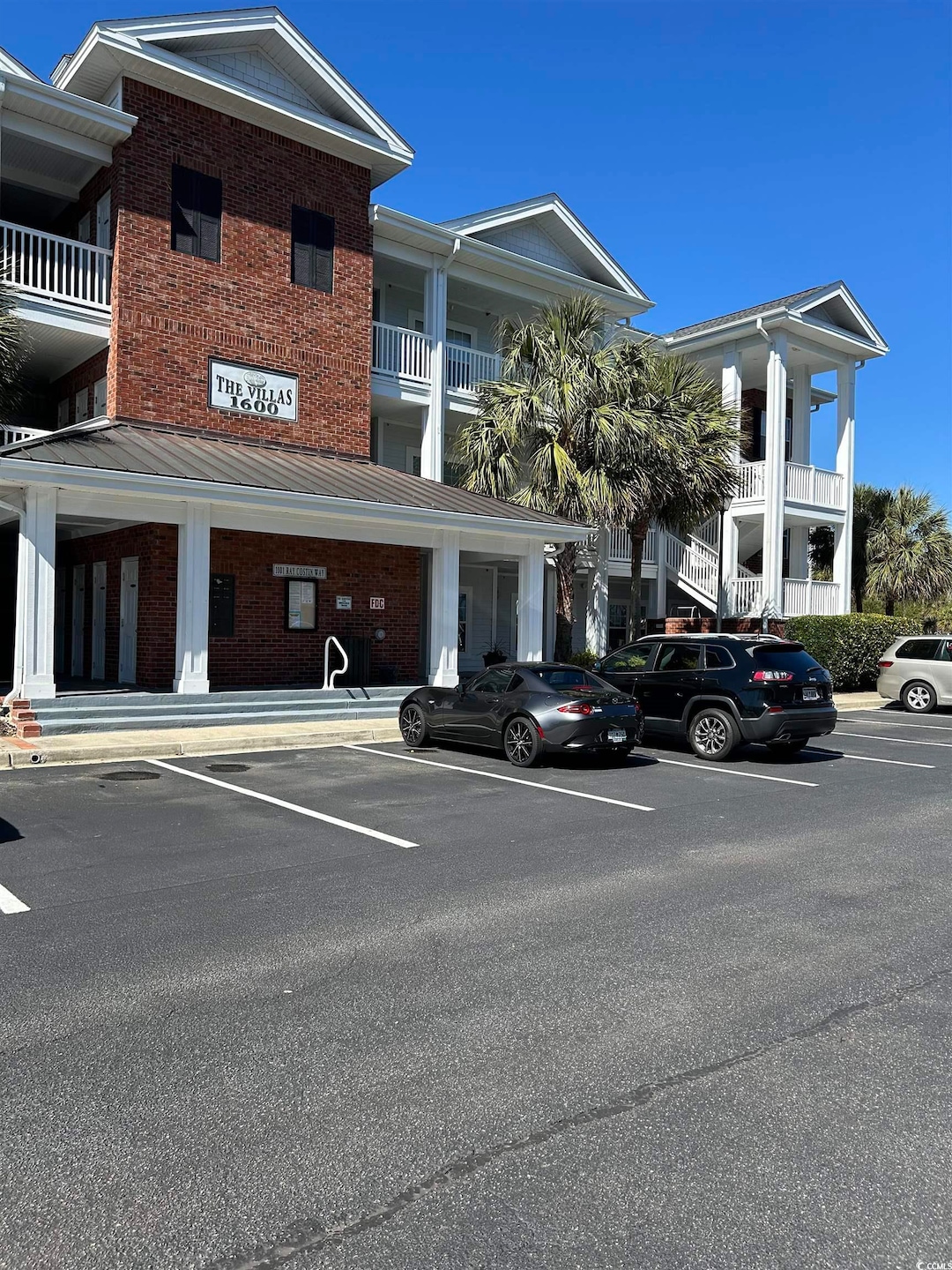View of property featuring uncovered parking