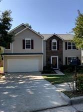 View of front of property with a garage, driveway, and stucco siding