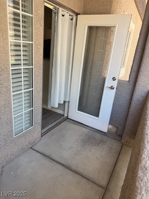 View of exterior entry with stucco siding