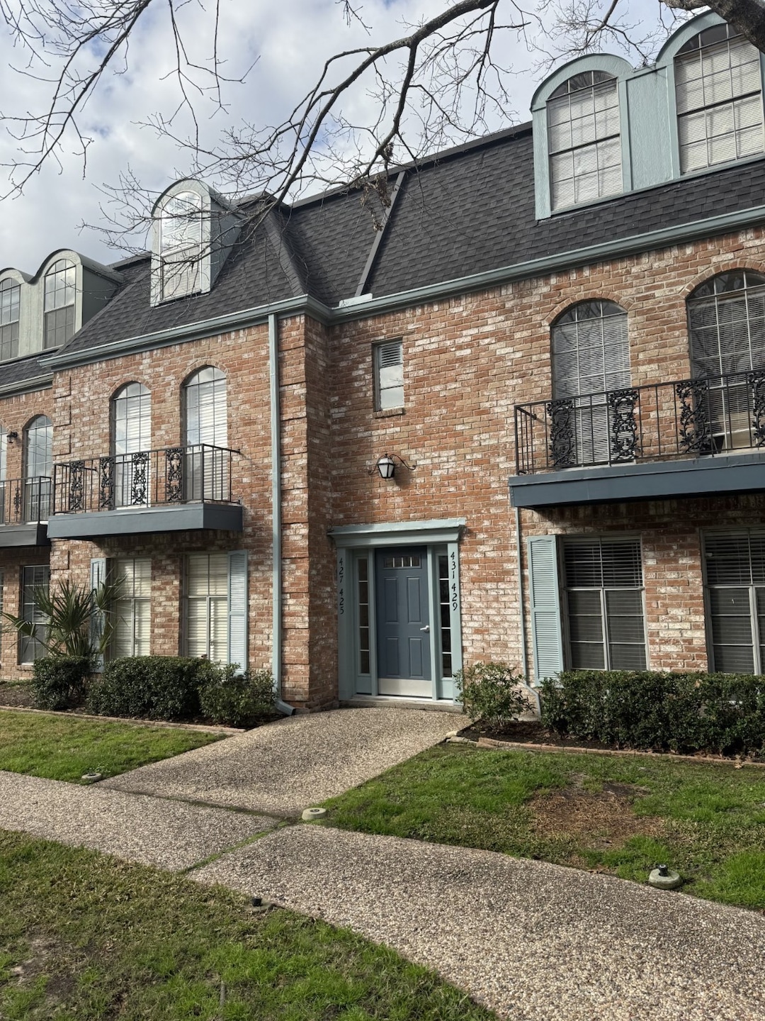 Townhome faces charming courtyard with pool